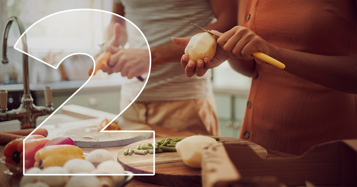 two people cutting vegetables
