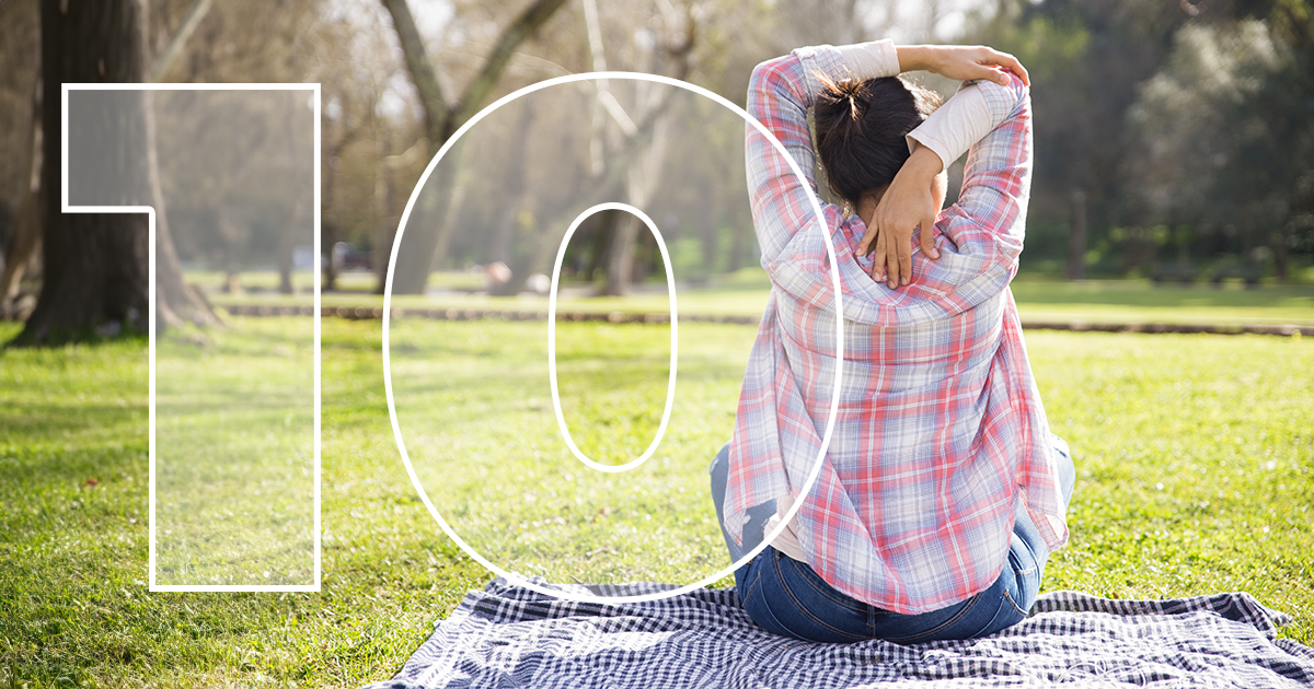 Woman relaxing in park sunny day plaid shirt