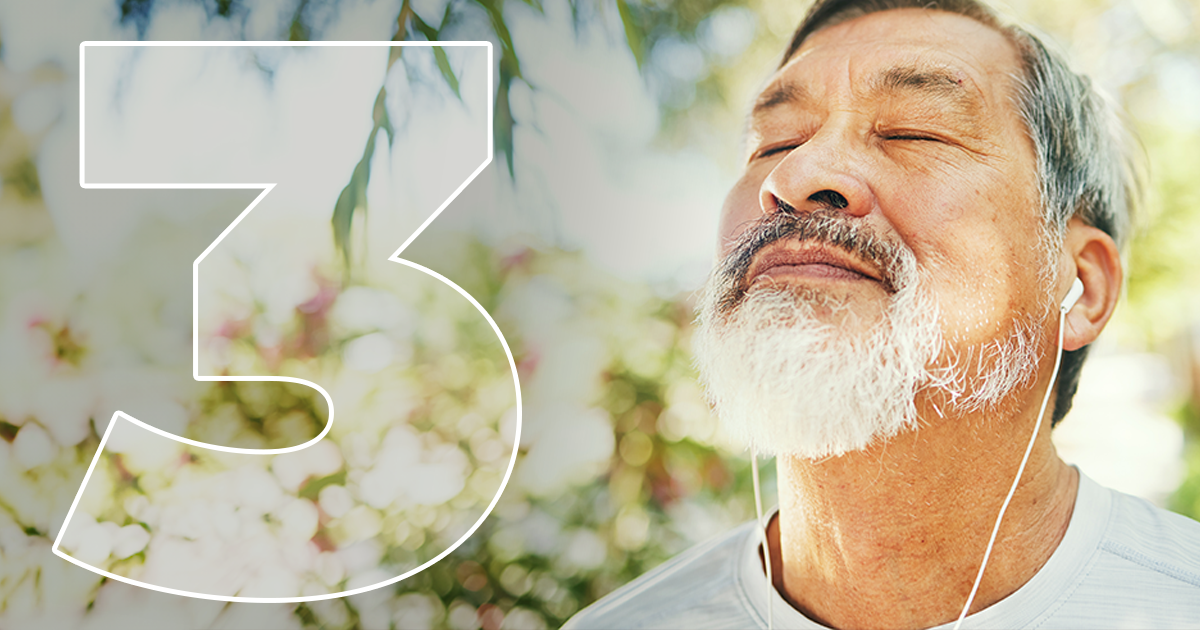 man taking deep breath outside